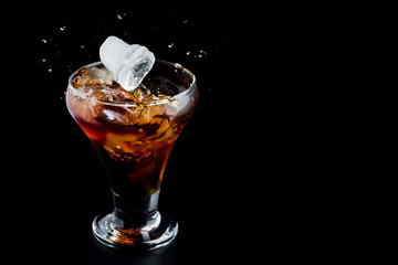 cold glass with whiskey on a black background