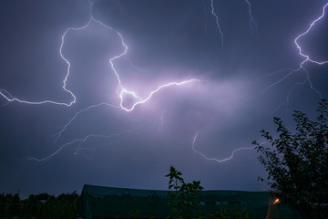 A lightningbolt travels in the sky over the countryside of Transylvania, Romania