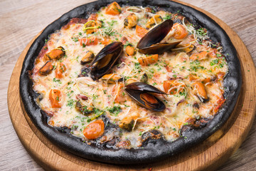 Black pizza with seafood