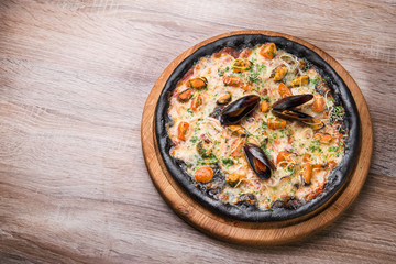 Black pizza with seafood