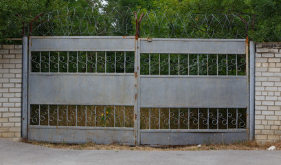 abandoned Old rusty gate coated barbed wire