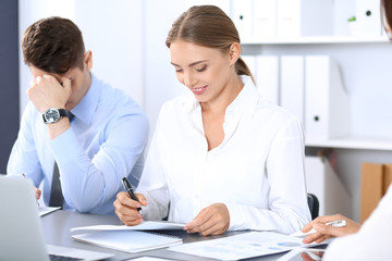 Obraz premium Group of business people or lawyers discussing terms of transaction in office. Meeting and teamwork concept