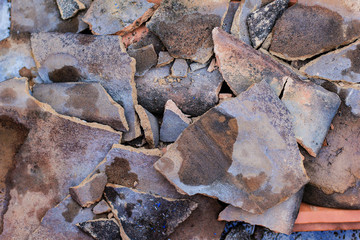 piles of broken roof tiles close up