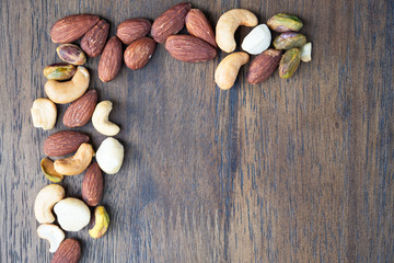 Many Dried peanuts on wooden table background and copy space ,space for text or images .