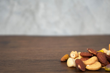 Many Dried peanuts on wooden table background and copy space ,space for text or images .
