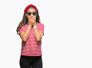 Young beautiful arab woman wearing sunglasses over isolated background shocked covering mouth with hands for mistake. Secret concept.