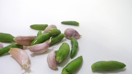 Peppers and garlic on a white isolate background.Use the recipe process or cookbook.Make a wallpaper,restaurant or billboard.