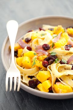 Tagliatelle with squash, cranberries and parsley