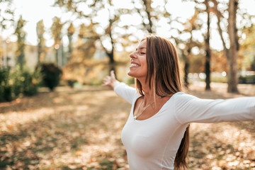 Young girl relaxing in the autumn park.