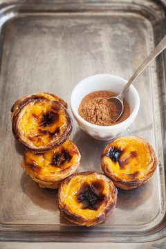Portuguese egg tart pastry and cinnamon in bowl