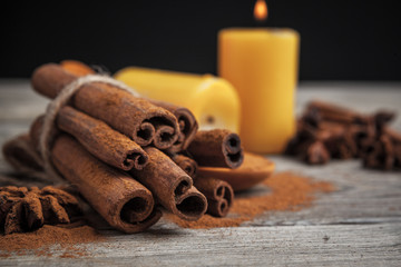 Cinnamon sticks on wooden background.