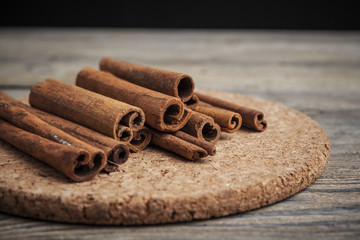 Cinnamon sticks on wooden background.
