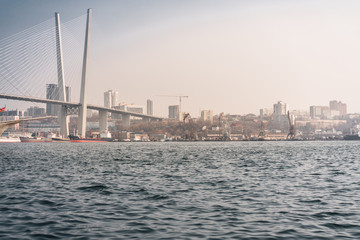Fototapeta premium White bridge over the sea. Urban landscape of Vladivostok