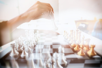 double exposure of businesswoman hand playing chess board game idea of management strategy and leadership concept