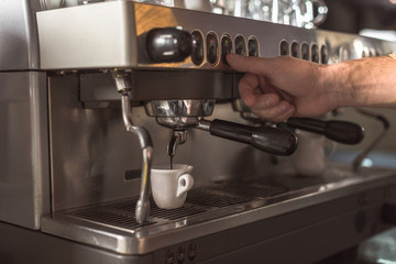 cropped shot of barista preparing coffee with coffee machine in cafe