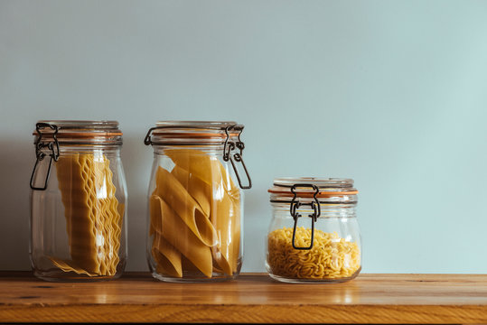 Glass Jars With Raw Pasta, On The Kitchen Shelf