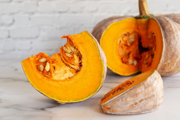 sliced raw pumpkin on marblel table background.