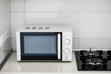 Modern kitchen interior with electric and microwave oven. 