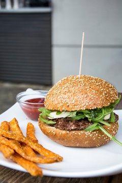A burger with sweet potato chips