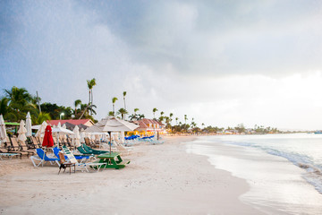 Fototapeta na wymiar Idyllic caribbean tropical beach with white sand, turquoise ocean water before the rain