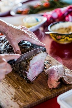 Neck of pork being cut into slices