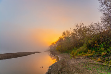 sunrise in the mist over the river