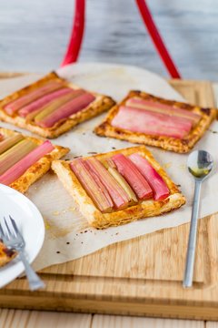 Rhubarb puff pastries served on wooden board