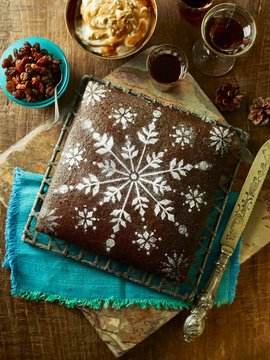 Gingerbread Christmas cake with icing sugar snowflake pattern