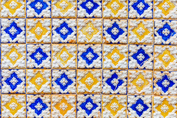Vintage tile wall pattern in the style of Portugal. Tiles in blue, white and yellow colors. Wallpaper, Linoleum, Textile, Web Page Background.