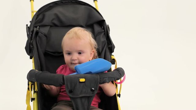 Discontented Infant Girl in a carriage