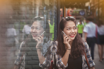 Fototapeta premium asian yonger woman toothy smiling face talking on mobile phone happiness emotion