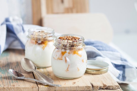Yogurt with orange pieces and chopped nuts