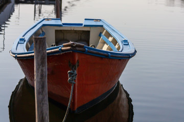Fototapeta na wymiar Small boat tied to a dock on a canal in Aveiro, Portugal