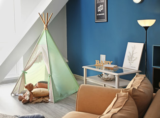 Cozy play tent for kids in interior of room