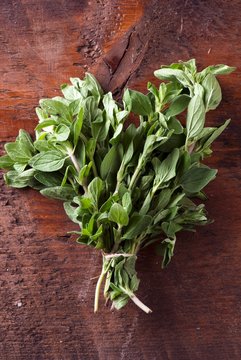 Overhead view of thyme leaves on wooden table