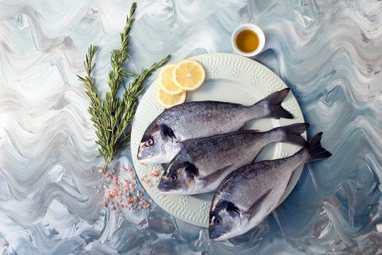 Fresh breams, lemons, salt and rosemary