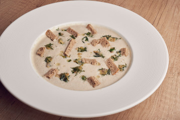 mushroom cream soup in white plate with crackers