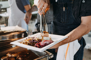 A chef serving dinner in a restaurant