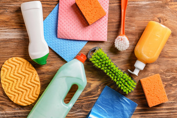 Cleaning supplies on wooden background