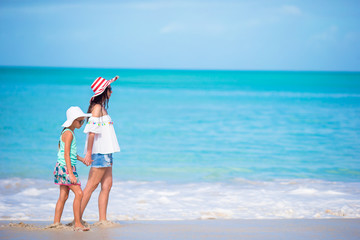 Beautiful mother and daughter on Caribbean beach. Family on beach vacation