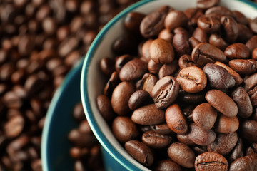 Cup with roasted coffee beans, closeup