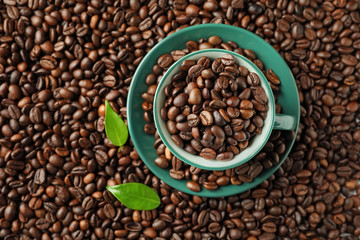 Cup on roasted coffee beans