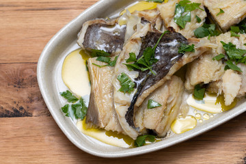 boiled cod fish with herbs and olive oil