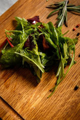 green salad leaves lie on wooden background