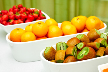 fruits on the table, oranges, kiwi, strawberries