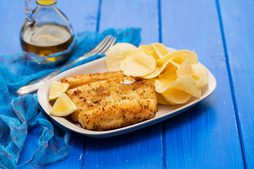 fried strips cuttlefish on white dish on blue background