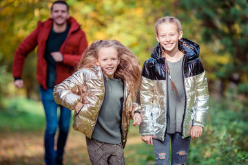Fototapeta premium Family of dad and kids on beautiful autumn day