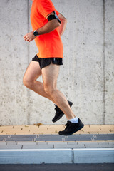 Fototapeta na wymiar Picture of man's legs running on the street. Healthy lifestyle concept.
