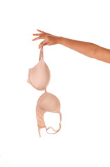 Woman's arm holding a beige bra