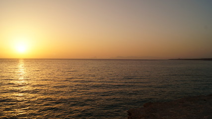 Sunset over Pacific Carribean beach showing dramatic red and yellow sky as sun sets 